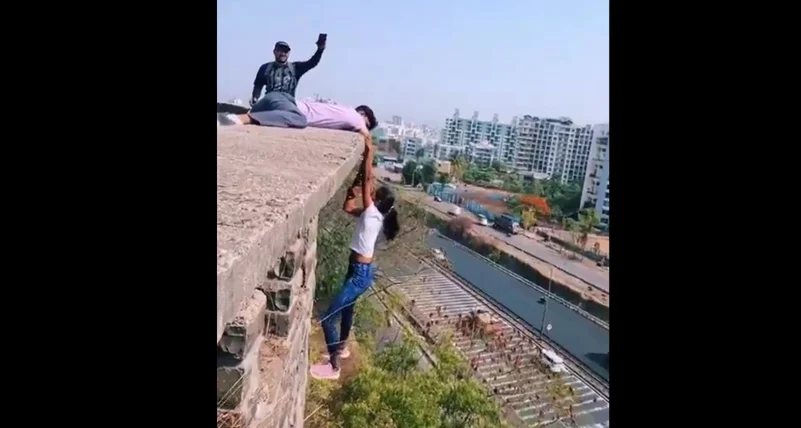 Viral Video Pune Woman Hangs From Building Roof Holding.0